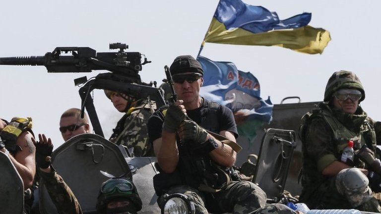 Ukrainian servicemen ride on armoured vehicles near Slaviansk