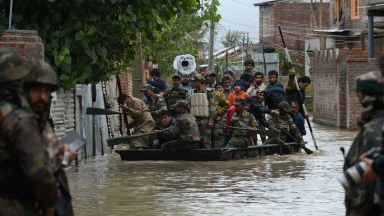 Indian soldiers paddle a raft as they assist Srinagar residents during a flood rescue operation, Indian-administered Kashmire, 5 September 2014