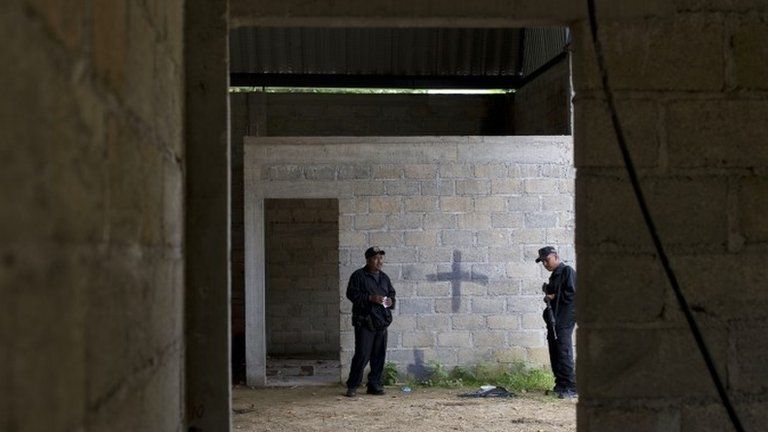 Mexican state police on 3 July 2014 inside a warehouse where a shootout between Mexican soldiers and alleged criminals on the outskirts of the village of San Pedro Limon, in Mexico state, Mexico