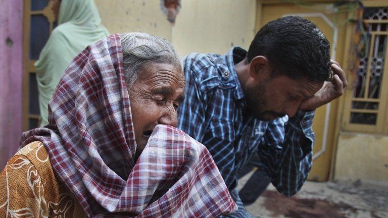 Relatives of Rajesh Kumar, who was killed in mortar shell firing allegedly from the Pakistan"s side, weep inside their residential house at Masha da kothe village, in Arnia Sector near the India-Pakistan international border, about 47 kilometers (30 miles) from Jammu, India, Monday, Oct. 6, 2014.