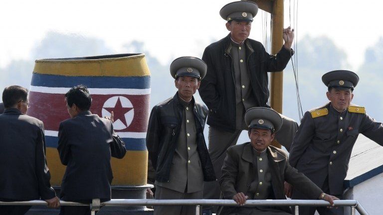 N Korean soldiers on a boat on the banks of the Yalu River (6 Oct 2014)