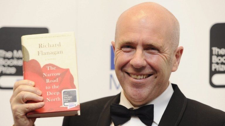 Australian novelist Richard Flanagan holds a copy of his book The Narrow Road to the Deep North