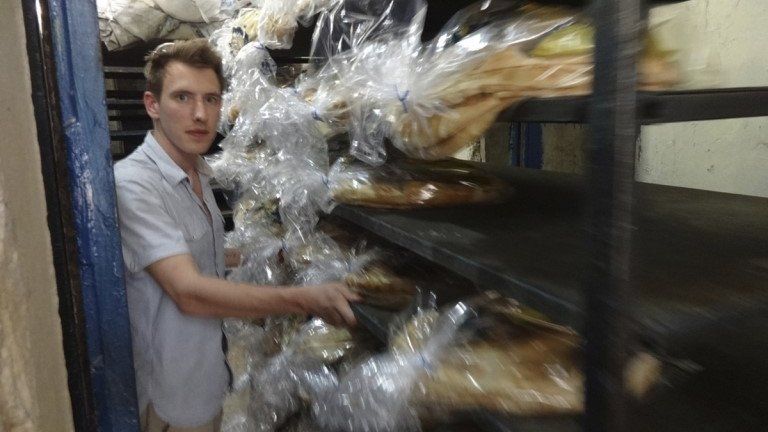 Peter Kassig collecting bread for delivery at an unknown location.