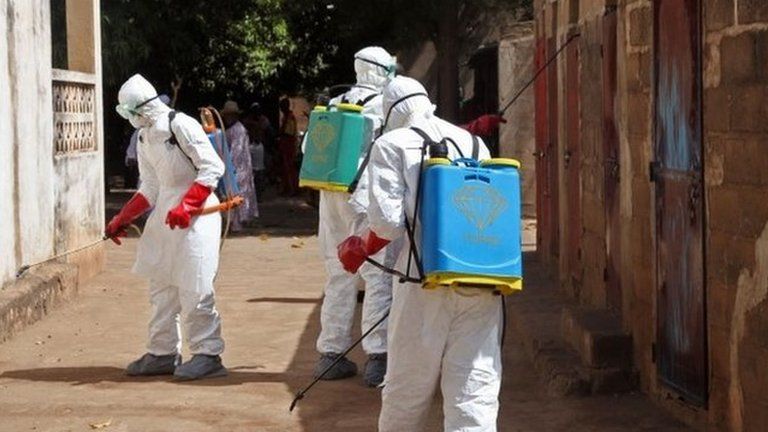 Health workers spray disinfectant a street in Bamako, Mali. Photo: November 2014
