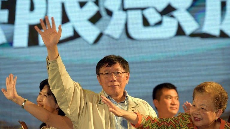 Taipei election winner Ko Wen-je waves in Taipei, 29 November