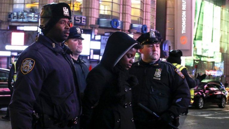 Police arrest a demonstrator at a protest over the death of Eric Garner in New York, 4 December