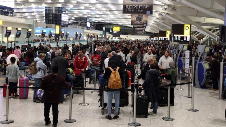 People waiting at Terminal 5 of Heathrow Airport