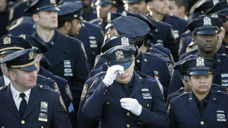 Police officers outside Christ Tabernacle Church in Queens, New York, 27 December