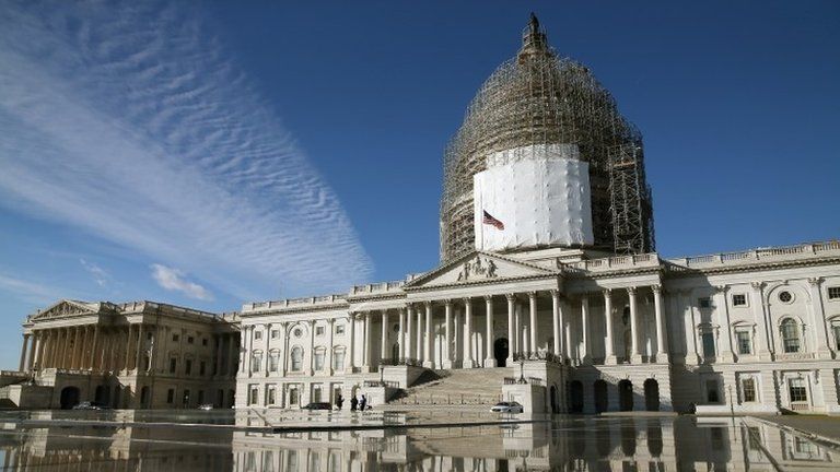 The US Capitol is reflected in a fountain, January 5, 2015 in Washington, DC.