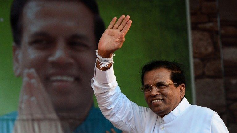 This file photo taken on November 30, 2014 shows Sri Lanka"s main opposition presidential candidate Maithripala Sirisena waving to the crowd during an election rally in the north-central town of Polonnaruwa.