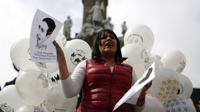 An activist holds a picture of missing journalist Moises Sanchez in Mexico City on 4 January, 2015.