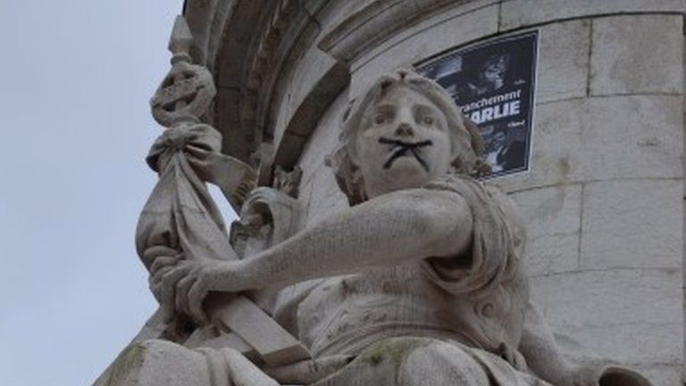 A statue on Place de la Republique, Paris, symbolically "gagged" by protesters, 10 January 2015