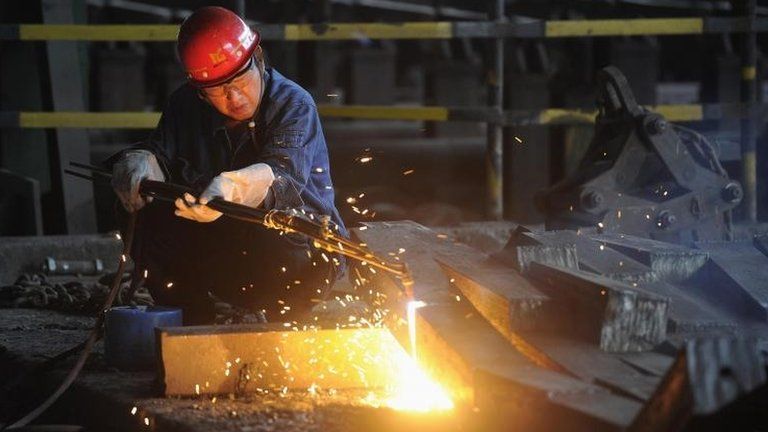 A worker cuts steel bars at a steel plant in China