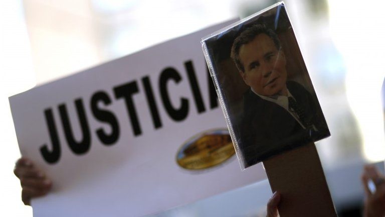 A woman holds up a picture of late Argentine prosecutor Alberto Nisman outside the AMIA Jewish community center during a demonstration to demand justice over Nisman"s death in Buenos Aires