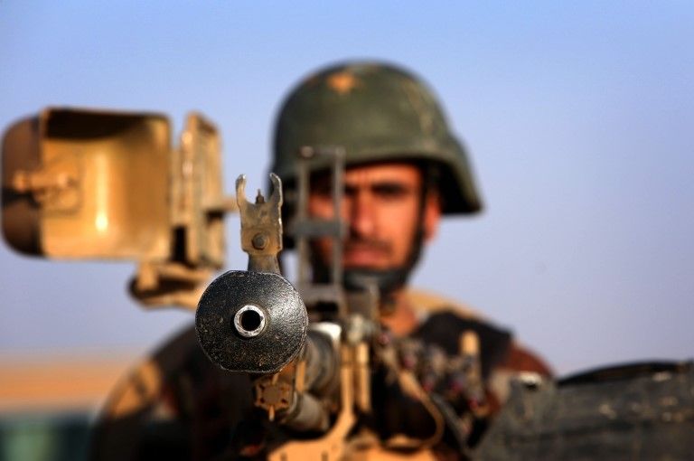 An Iraqi Kurdish Peshmerga fighter takes position on the front line in Khazer, near the Kurdish checkpoint of Aski kalak, August 2014