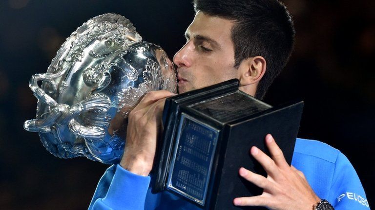 Novak Djokovic celebrates with the trophy