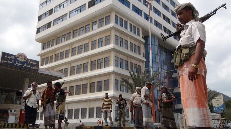 Members of the Popular Resistance Committees (PRC) stand guard outside the television building in Aden, Yemen (16 February 2015)