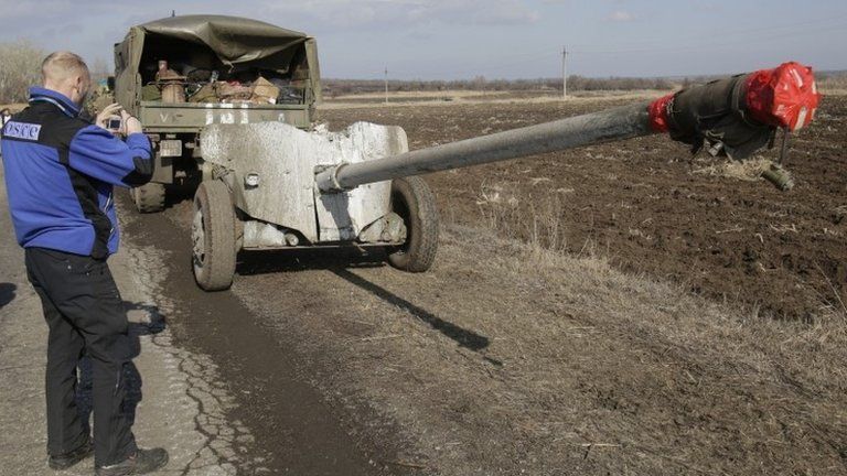 An OSCE observer takes a picture of Ukrainian artillery near Soledar, in the Donetsk region, 27 February