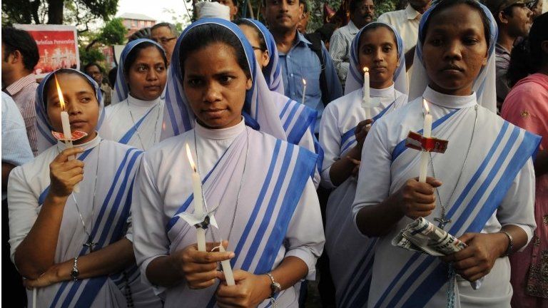 Indian nuns and residents take part in a vigil and protest against the gang-rape of a nun at a convent-school in Kolkata on March 16, 2015