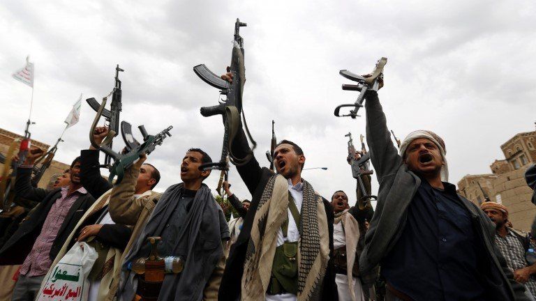 Houthi members hold their guns in the air while shouting anti-Saudi slogans during a rally protesting Saudi-led airstrikes against Houthi positions in Sana’a, Yemen, 26 March 2015