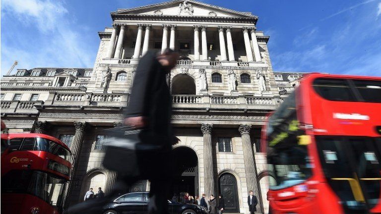 A pedestrian passes the Bank of England in London,