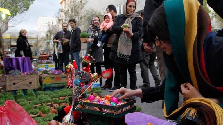 Iranians go shopping at a street market