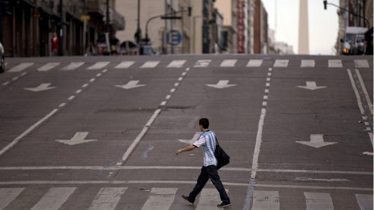 A man crosses an avenue during a transportation strike in Buenos Aires, on 31 March, 2015.