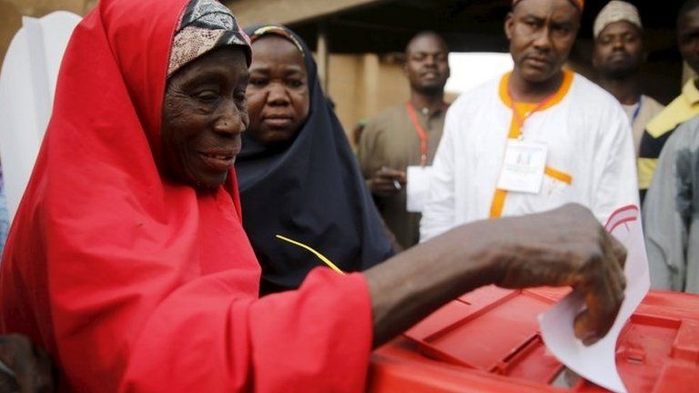 A woman casts her vote at a polling unit in Daura