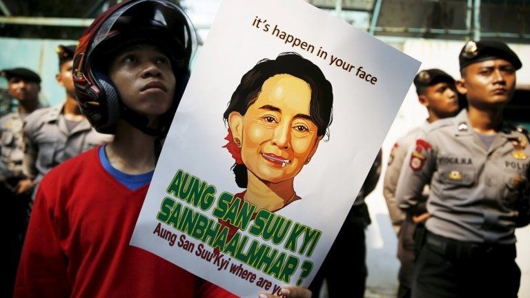 Student holds poster of Aung San Suu Kyi