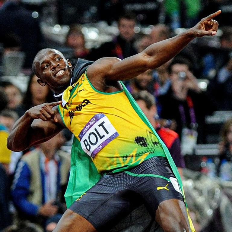 Usain Bolt holds his signature celebration pose after winning gold at London 2012