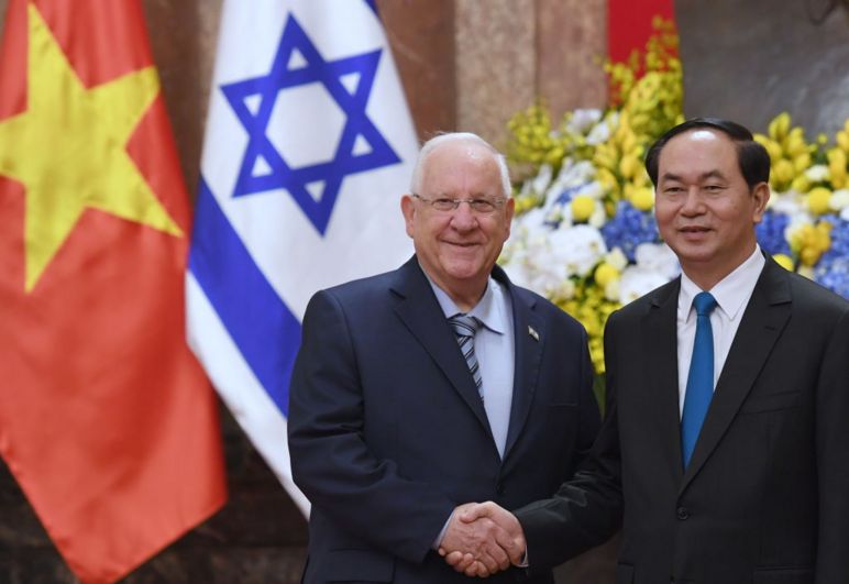Israel's President Reuven Rivlin (L) shakes hands with his Vietnamese counterpart Tran Dai Quang during a welcoming ceremony at the presidential palace in Hanoi on March 20, 2017