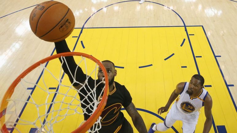 LeBron James #23 of the Cleveland Cavaliers dunks the ball ahead of Kevin Durant #35 of the Golden State Warriors in Game 5 of the 2017 NBA Finals at ORACLE Arena on June 12, 2017 in Oakland, California