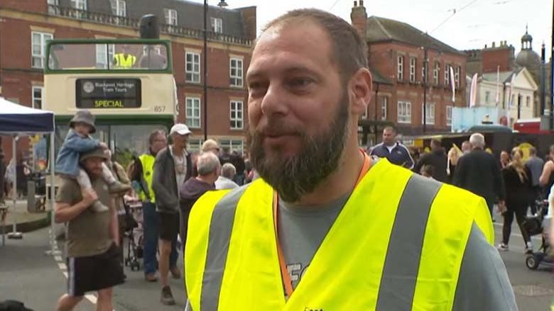 Robert Kane standing in front of crowds in Fleetwood