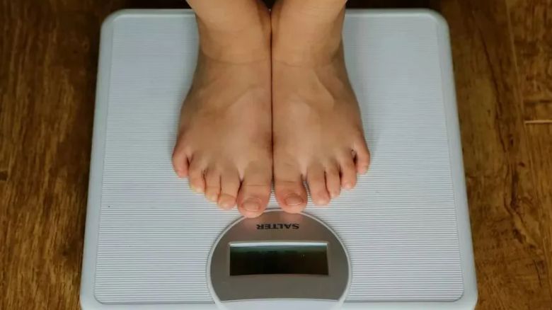 Person measuring their weight