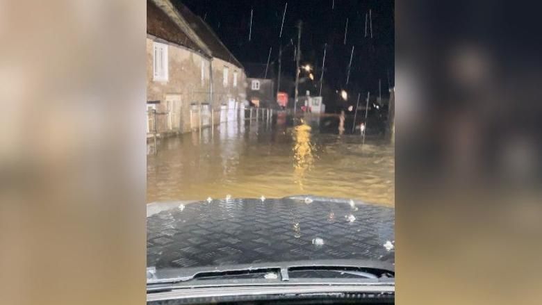 Flood waters in Croscombe coming over a bonnet