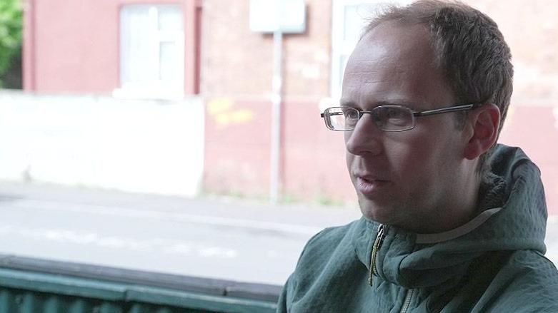 Pete wearing a green jacket in a cafe in Withington, Manchester
