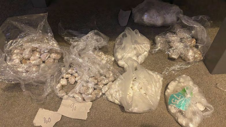 Seven plastics bags filled with crack cocaine and heroine parcels on the floor inside the property