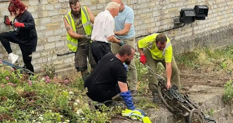 People in high-viz jackets clearing out river