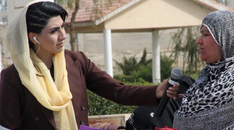 Reporter Shazia Haya is pictured interviewing another woman in Afghanistan