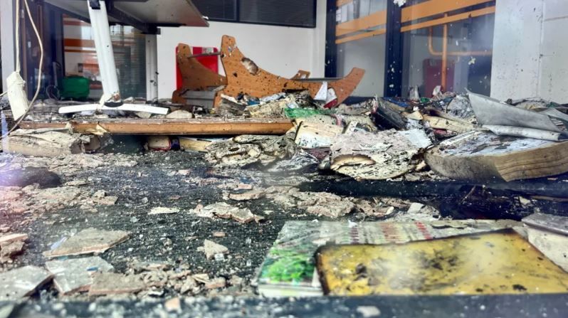 Damage to Spellow library in Liverpool showing rubble and ash on library floor