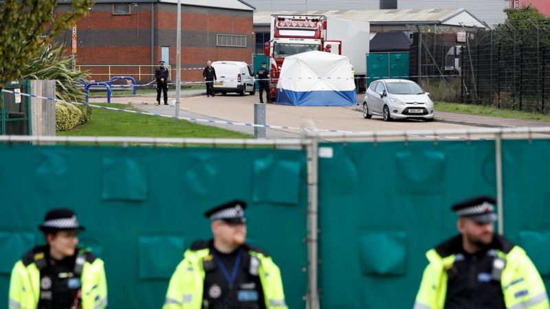 Police guard the location in Purfleet where the bodies of 39 people were found in a truck