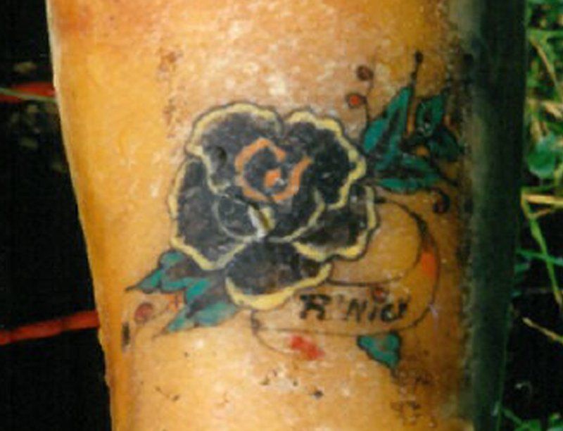 An image of the flower tattoo on the unidentified woman