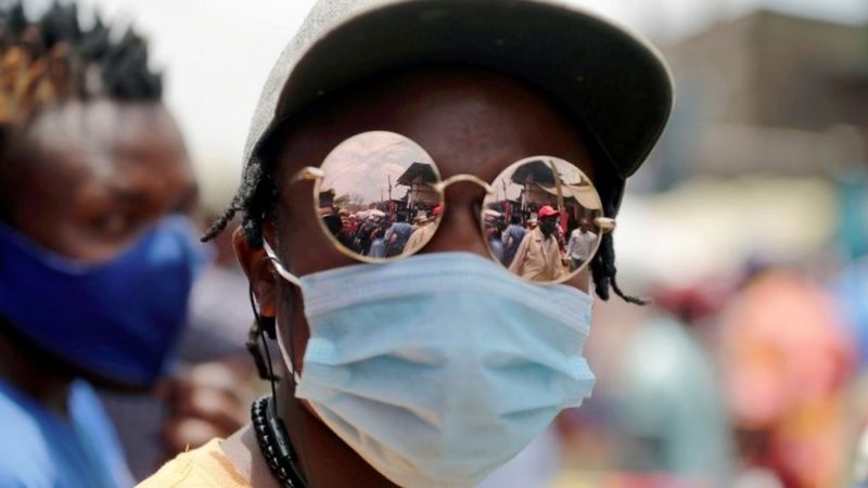 A customer wears reflective glasses as he selects imported second-hand clothes amid the coronavirus disease (COVID-19) outbreak at the Gikomba market in Nairobi, Kenya, in this photo released on 29 September Picture taken September 18, 2020