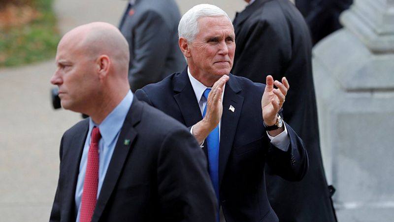U.S. Vice President Mike Pence reacts to supporters outside the New Hampshire State House as he walks near his Chief of Staff Marc Short