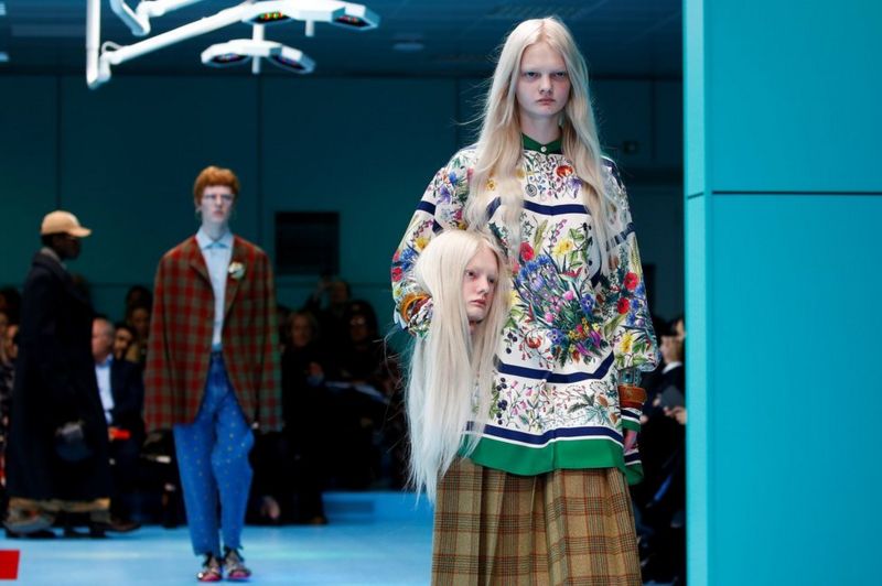 Milan Fashion Week: Models carry fake heads on Gucci catwalk - BBC News