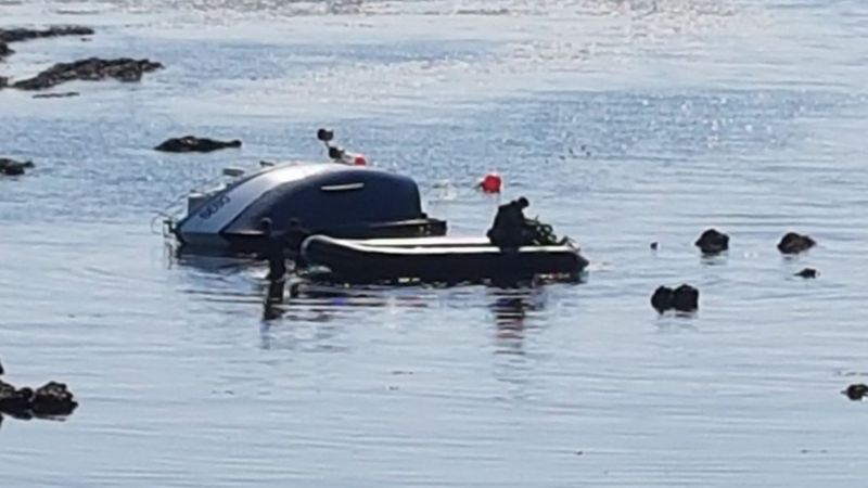 Man washed up on beach after fishing boat capsizes - BBC News