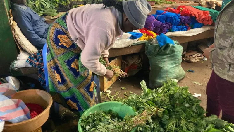 Vegetable vendor Priscilla Njeri at her market stall