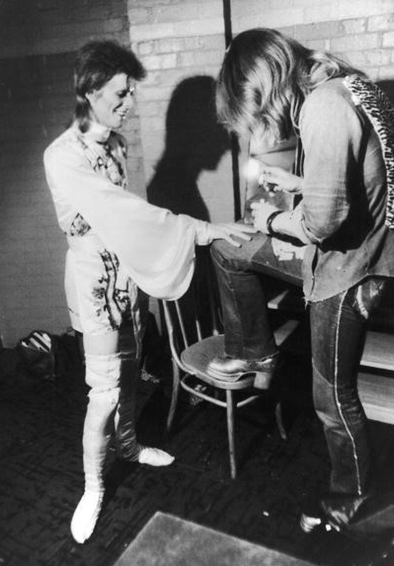 Make-up artist Pierre La Roche prepares English singer David Bowie for a performance as Aladdin Sane, 1973. Bowie is wearing a costume by Japanese designer Kansai Yamamoto.