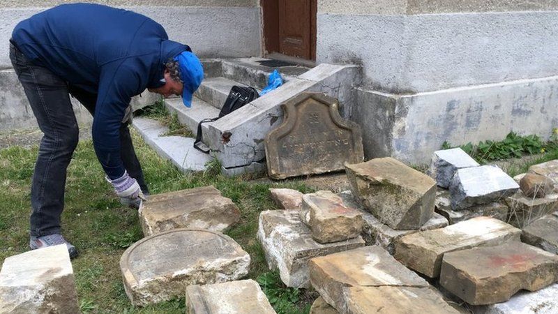 Tomas Jelinek cleaning some of the headstones