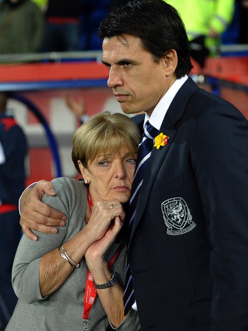 Carol is comforted by Wales manager Chris Coleman at a 2012 international memorial game for her son